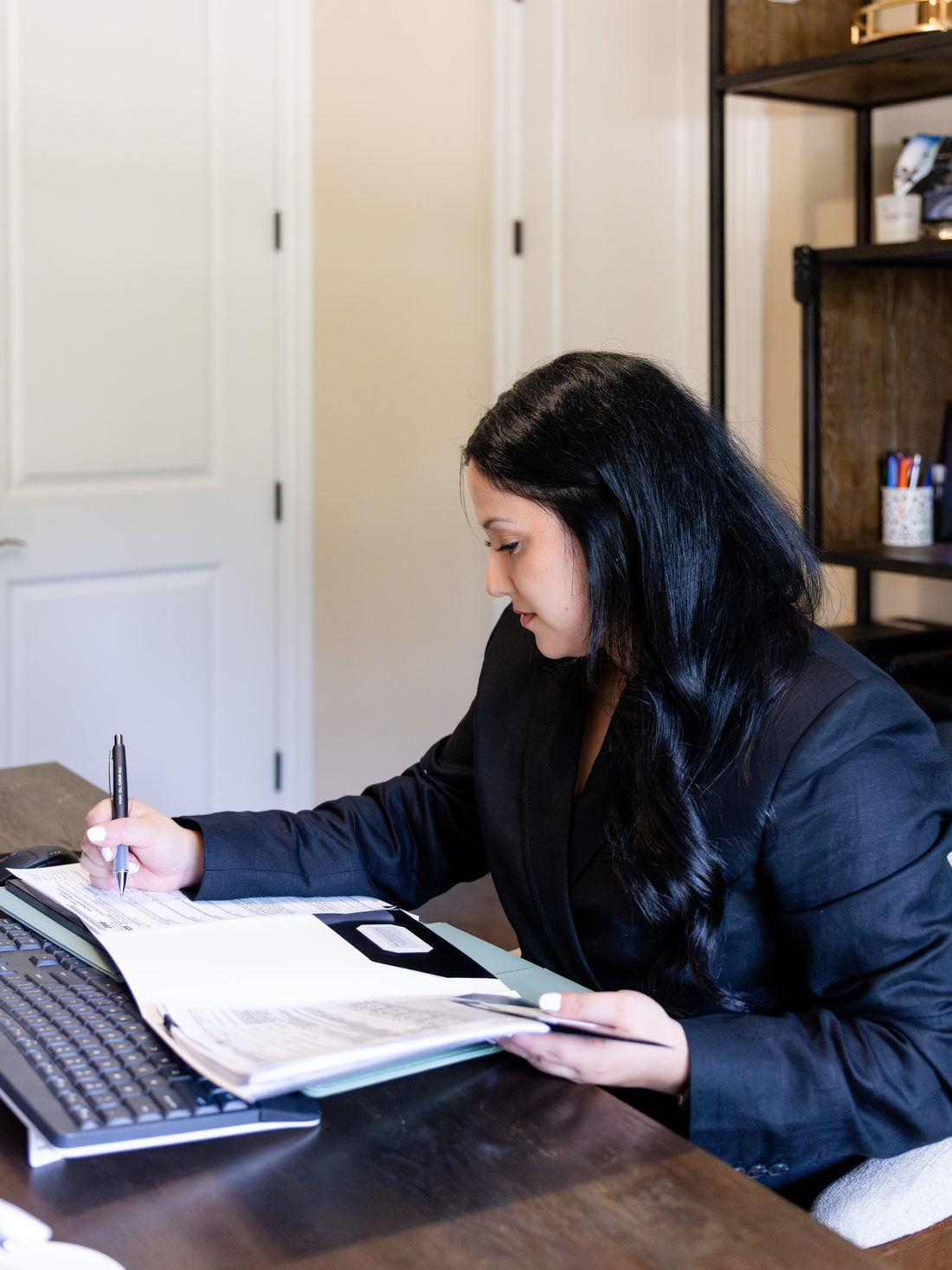 Sandra Gonzalez reviewing a client's documents at True Tax & Accounting